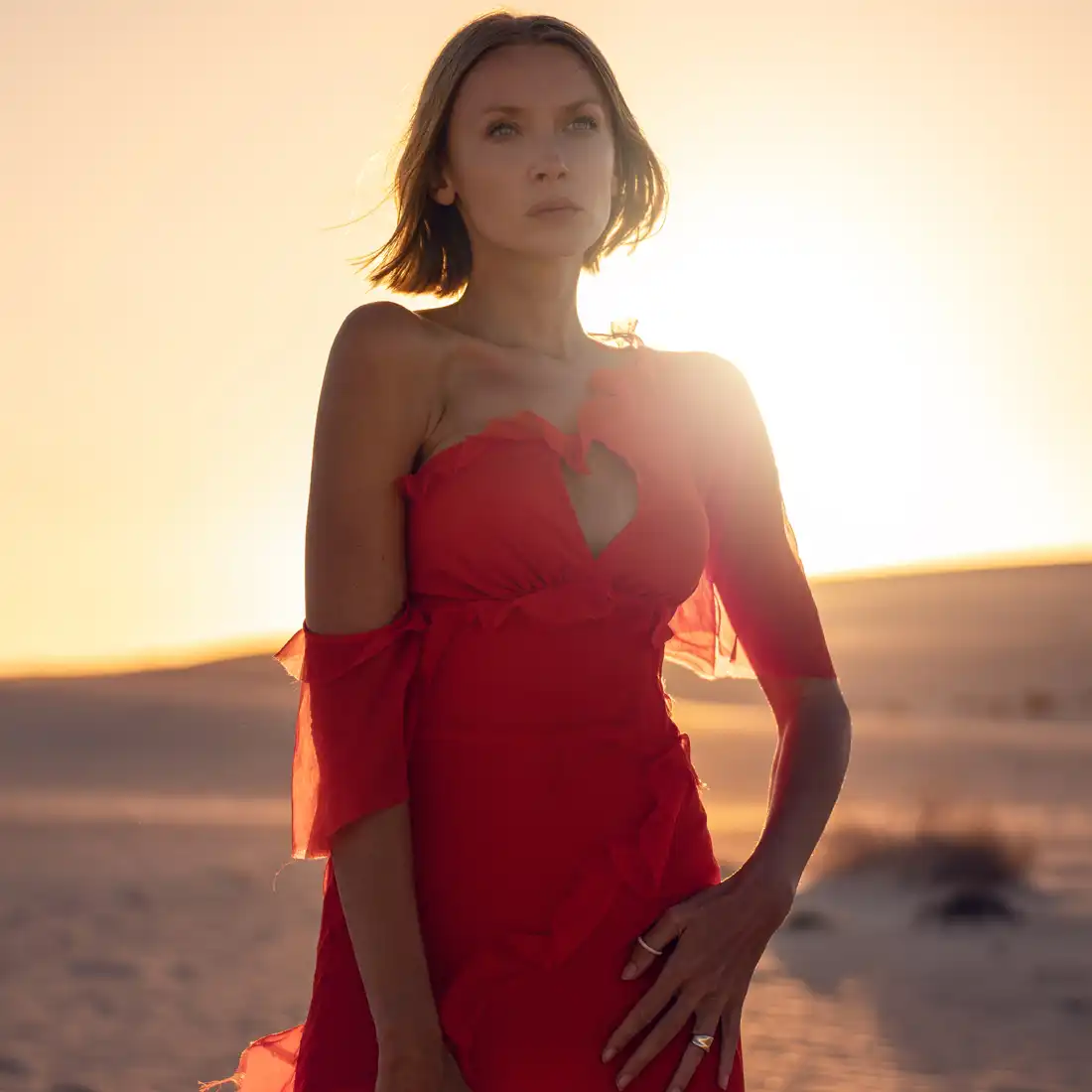 woman in red dress staning in desert | chin filler in miami